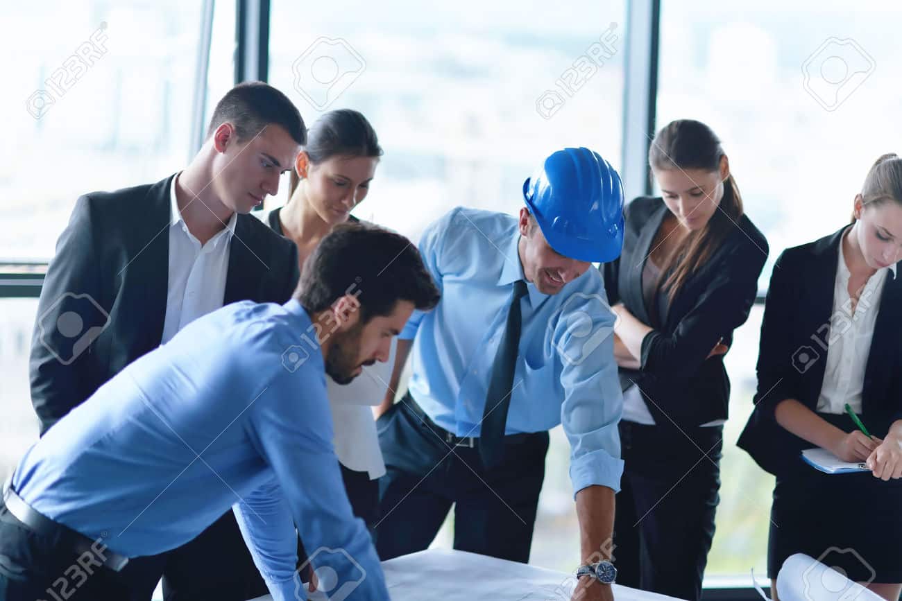 24325004-business-people-group-on-meeting-and-presentation-in-bright-modern-office-with-construction-engineer-Stock-Photo.jpg
